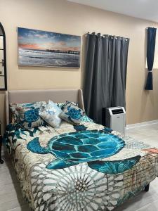 a bedroom with a bed with a quilt on it at Coastal Escape Walkable, Cozy Pet-Friendly in Jacksonville Beach