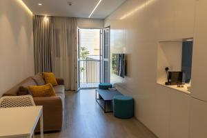 a living room with a couch and a table at City Centre Studio Apartments Nicosia in Nicosia