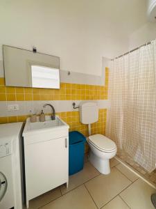 a bathroom with a toilet and a sink and a mirror at Villetta del Moro in Villaggio Azzurro +11 photos