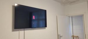 a flat screen tv hanging on a wall at City Apartment 2 Triberg in Triberg