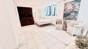 a living room with white furniture and a couch at Studio am Waldbach in Gernsbach