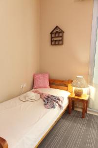 a small bedroom with a bed and a lamp at MASTIHA SeaSide Emporios Apartments in Emporeios