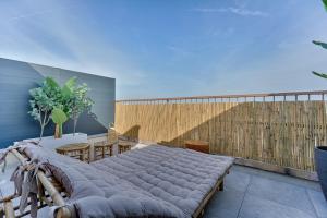 a bedroom with a bed on a balcony at Welcome to Corsica Love in Alfortville