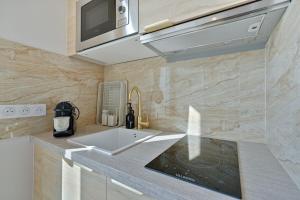 a kitchen with a sink and a microwave at Welcome to Corsica Love in Alfortville +16 photos