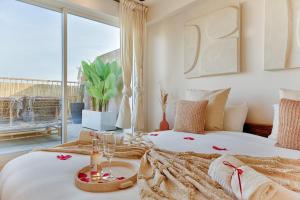 a bedroom with a large bed and a large window at Welcome to Corsica Love in Alfortville