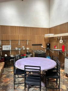 a kitchen with a large purple table and chairs at CHÁCARA recanto das nuvens 2 in Arujá