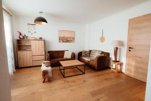 a living room with a couch and a table at Chalet Bergglück in Piesendorf