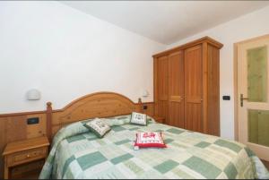 a bedroom with a bed with two pillows on it at Casa Clelia in Pellizzano +7 photos