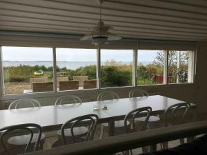 a white table and chairs in front of a large window at Beach Cottages in Höllviken