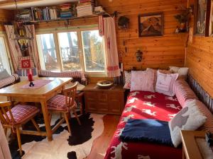 a living room with a couch and a table in a cabin at Almhütte Steirische Botschaft in Aflenz Kurort