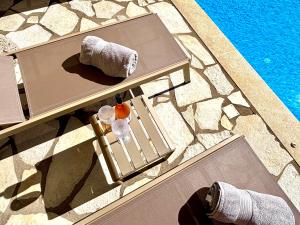an overhead view of a table next to a pool at The Lookout, boutique villa. in Sivota +43 photos