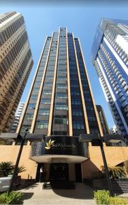 a tall building with a sign in front of it at Hotel & Residência Alphaville in Barueri