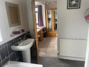 a bathroom with a sink and a mirror at Camaraderie Guest House in York