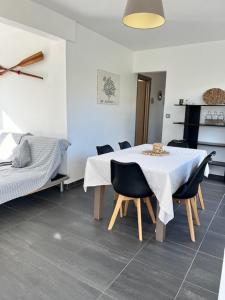 a dining room with a white table and chairs at Villa des 4 saisons in Cucq +11 photos