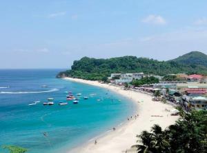 a view of a beach with boats in the water at Marias couple room in Puerto Galera