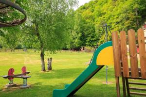 a playground with a slide in a park at gîte Le Pressoir in Monceaux-sur-Dordogne