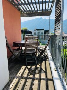 a patio with a table and chairs on a balcony at Résidence 3 bord du lac logement T3 piscine spa in Aix-les-Bains