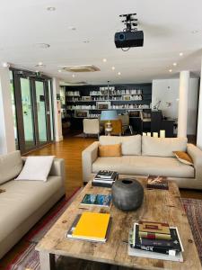 a living room with two couches and a table at Résidence 3 bord du lac logement T3 piscine spa in Aix-les-Bains +12 photos