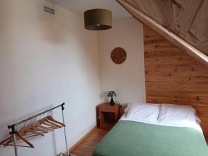 a bedroom with a bed and a wooden ceiling at Charmant appartement au centre de Bagnères-de-Bigorre in Bagnères-de-Bigorre +18 photos