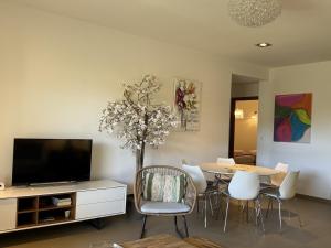 a living room with a dining table and a tv at T3 Cote Plage n 19 by Pinarello Villa Services in Pinarellu +9 photos