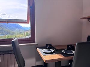 a dining room table with a view of the mountains at Valley View Studio in Saint Vincent