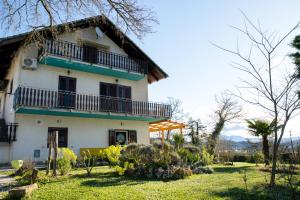 a house with a balcony and a yard at Farm stay Synergia - Hiden treasure in Pazin
