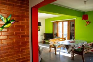 a dining room with a table and green walls at Farm stay Synergia - Hiden treasure in Pazin