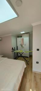 a room with two beds and a table in it at LEYLİ GABAN VİLLA in Çaykara