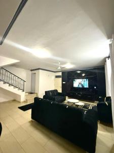 a living room with a couch and a flat screen tv at Greenwood Garden 3Bedroom Mtwapa in Mtwapa +12 photos
