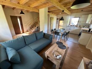 a living room with a blue couch and a table at Przystanek Zawóz in Zawóz
