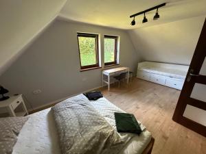 a bedroom with a bed with a laptop on it at Przystanek Zawóz in Zawóz