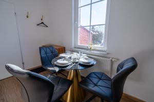 a dining room with a table and chairs at Aurora Schaar 2 in Wilhelmshaven +11 photos