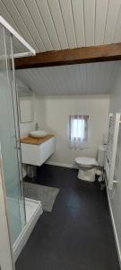 a bathroom with two toilets and a sink and a shower at Le bol d'air in Saint-Martin-le-Mault +8 photos