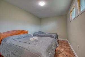 a bedroom with two twin beds and a window at 201 Cabins in Jackman