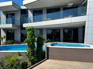 an external view of a building with a swimming pool at Apartment Villa Marjanovic in Opatija