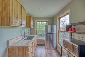 a kitchen with wooden cabinets and a stainless steel refrigerator at 201 Cabins in Jackman