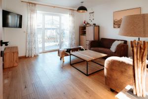 a living room with a couch and a coffee table at Chalet Bergglück in Piesendorf