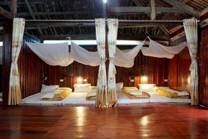a large bed in a room with a canopy at Kim in Cao Bằng