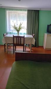 a table and chairs in a room with a window at Еко дом с верандой с видом на горы in Borjomi