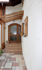 a front door of a house with a wooden door at Ferienhaus mit Garten für bis zu 6 Personen in Rosenheim