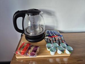 a tea pot and some candy on a table at Manesty House - Rooms only - no kitchen-living in Keswick