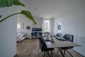 a dining room with a table and chairs at Aurora Schaar 1, 120qm, WiFi, Maisonette, Modern,2 Schlafzimmer, 1 Wohnzimmer in Wilhelmshaven
