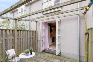 a patio with a pink door and a table at Cozy Oasis perfect for couples & solo travelers in Viborg