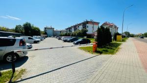 a parking lot with cars parked on a street at Apartament w Centrum in Przemyśl