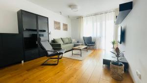 a living room with a couch and a chair at Apartament w Centrum in Przemyśl