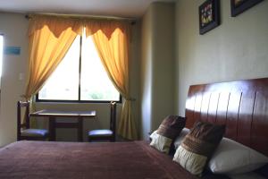 Uma cama ou camas num quarto em Hotel Onix Gold