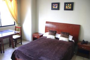 Uma cama ou camas num quarto em Hotel Onix Gold