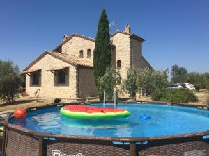 a watermelon pool in front of a building at Villa Miranda in Porchiano