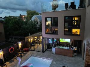 a house with a swimming pool in the backyard at Palanga Classic White Studio in Palanga