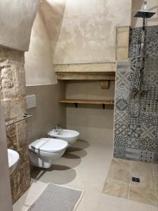 a bathroom with a toilet and a sink and a shower at 17 per 2 in Martina Franca